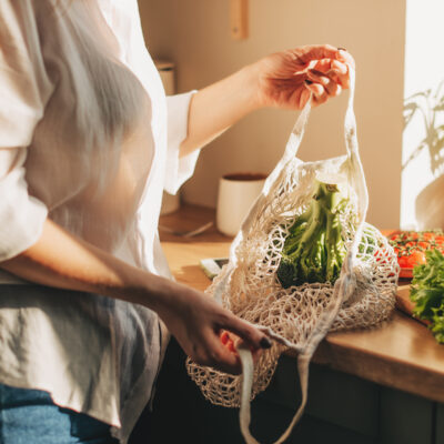 woman unloading-vegetables from market bags