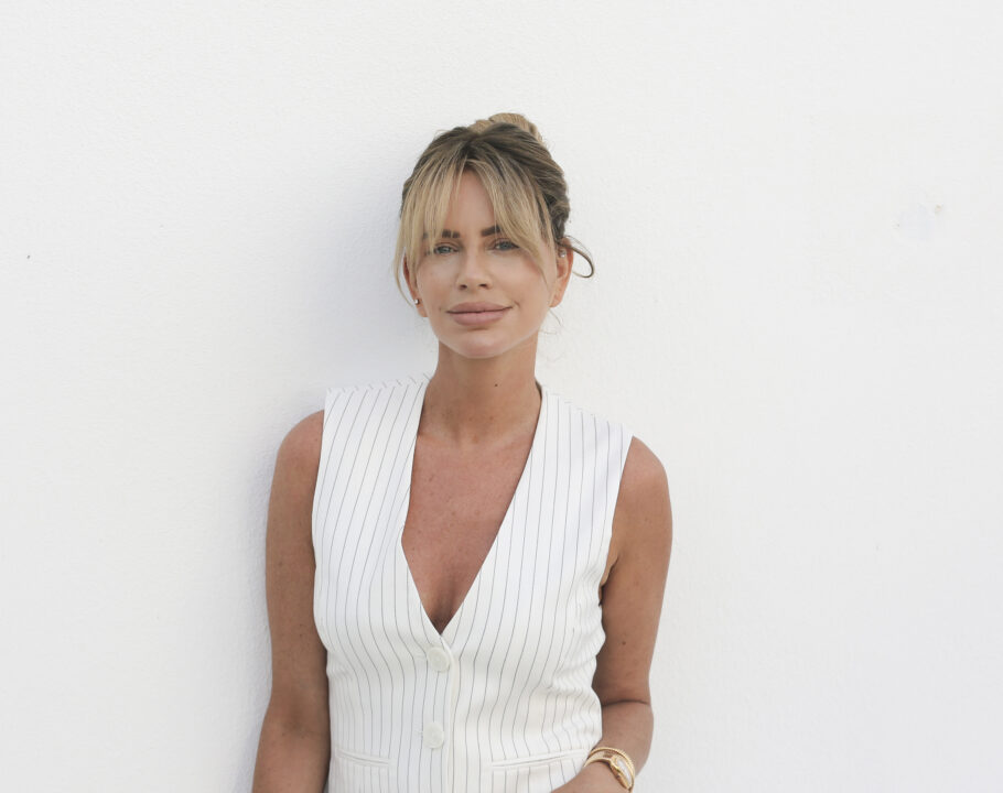 Caroline Stanbury in a white vest in front of white background