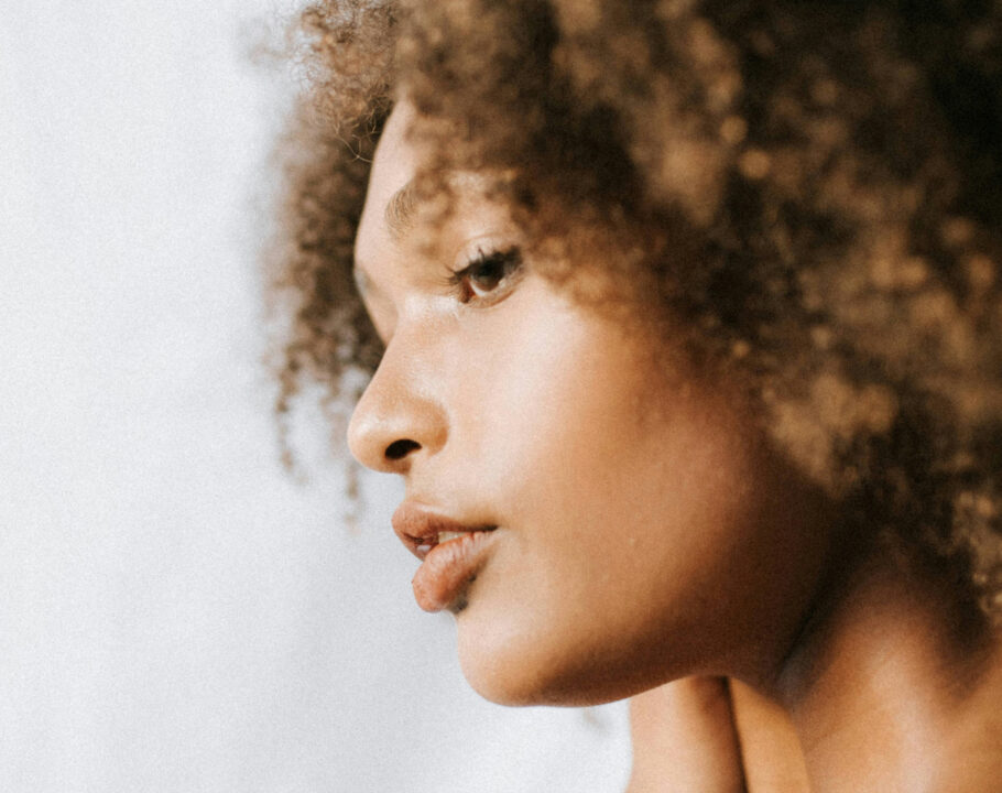 side view of curly-haired Black woman's face