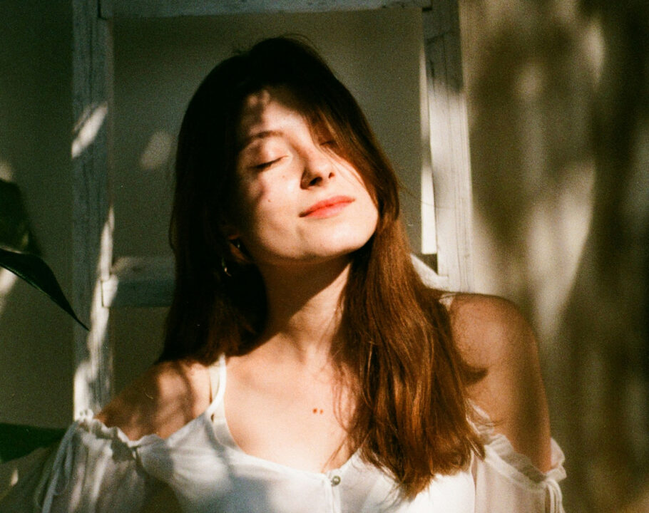 Woman with eyes closed with sunshine on her face