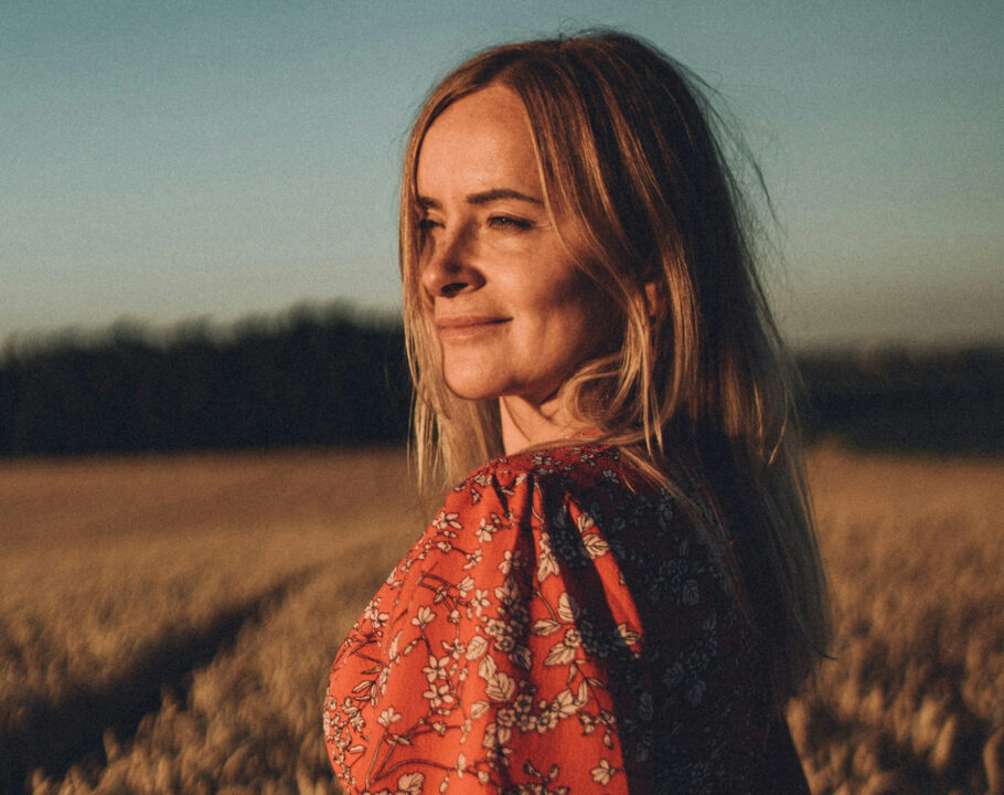 woman in field at sunset