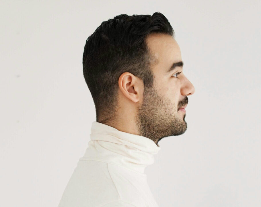 side profile of man in a white turtleneck