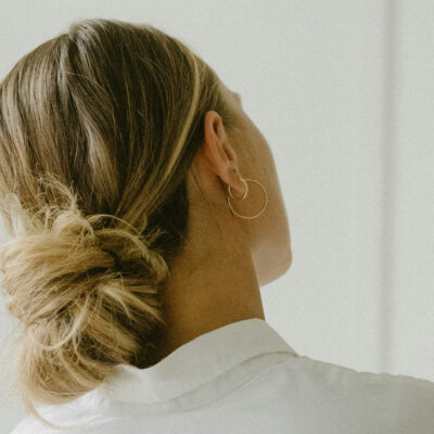 back view of woman with blonde hair in low bun