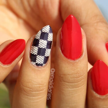 red manicure with checkerboard accent nail