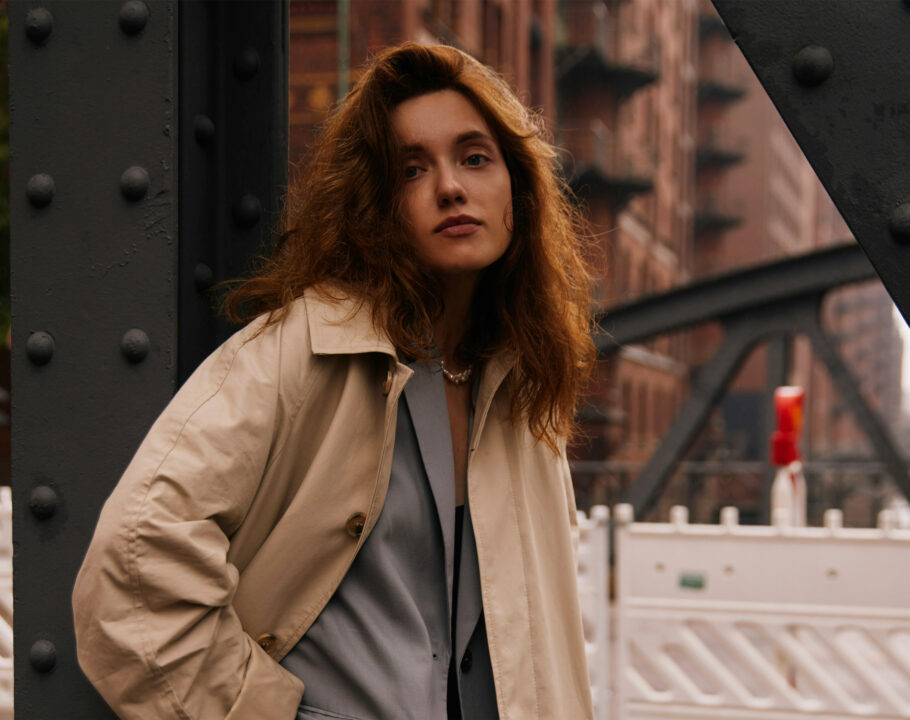 woman standing outdoors in trenchcoat