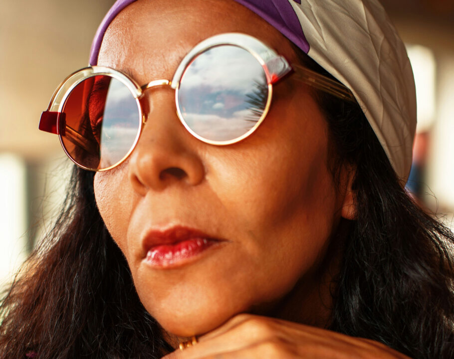 Mature woman's face with sunglasses and head scarf on