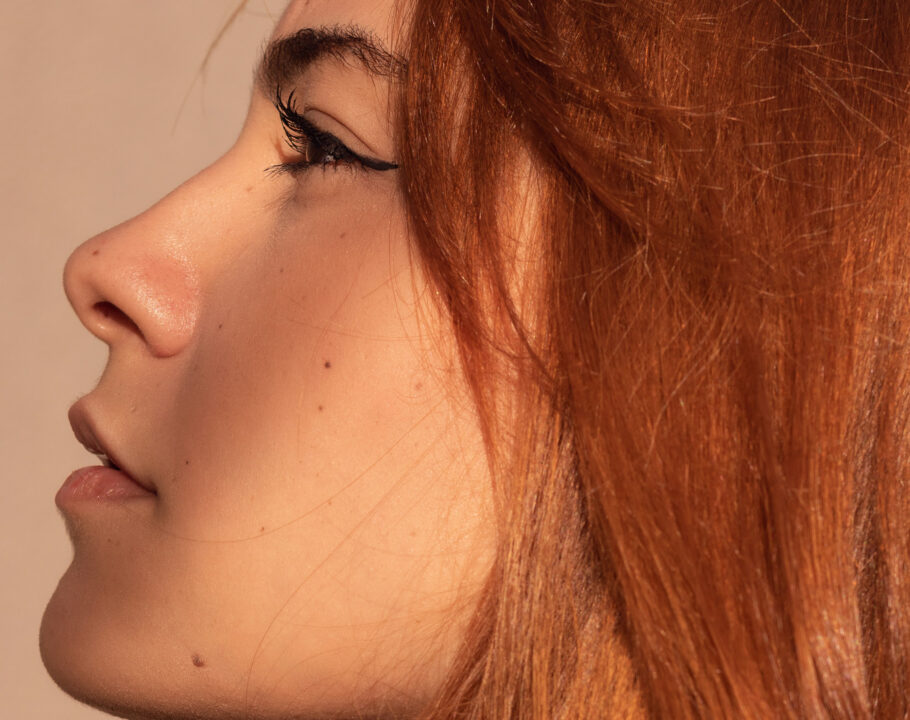 woman with red hair looking to the side