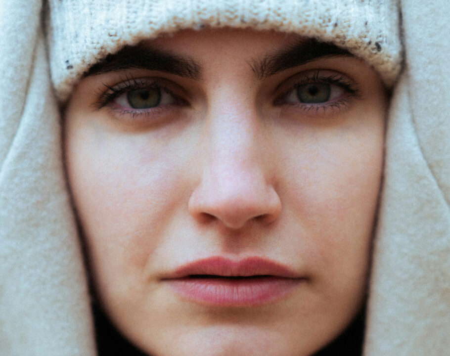 close up of woman's face who is wearing a winter hat