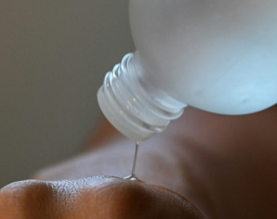 skin care liquid being poured on to hand