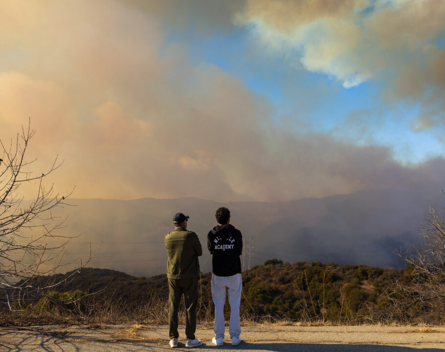 Civilians watch the Palisades Fire, along Mandeville Canyon, photographed from the Mountaingate development, above Mandeville, January 11, 2025, in the Brentwood community of Los Angeles, California.