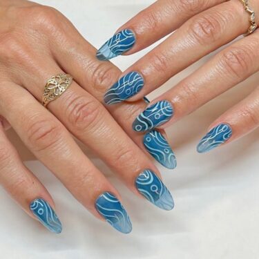 Translucent blue nails with wavy nail art